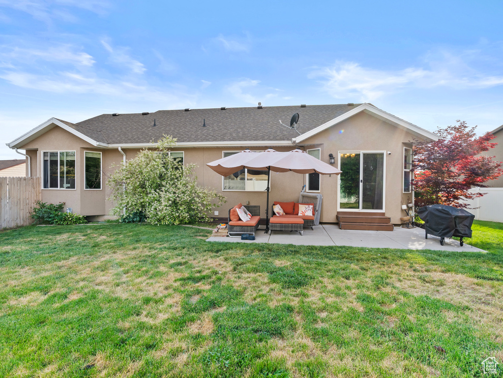 Rear view of property featuring a patio area, entry steps, stucco siding, and a shingled roof