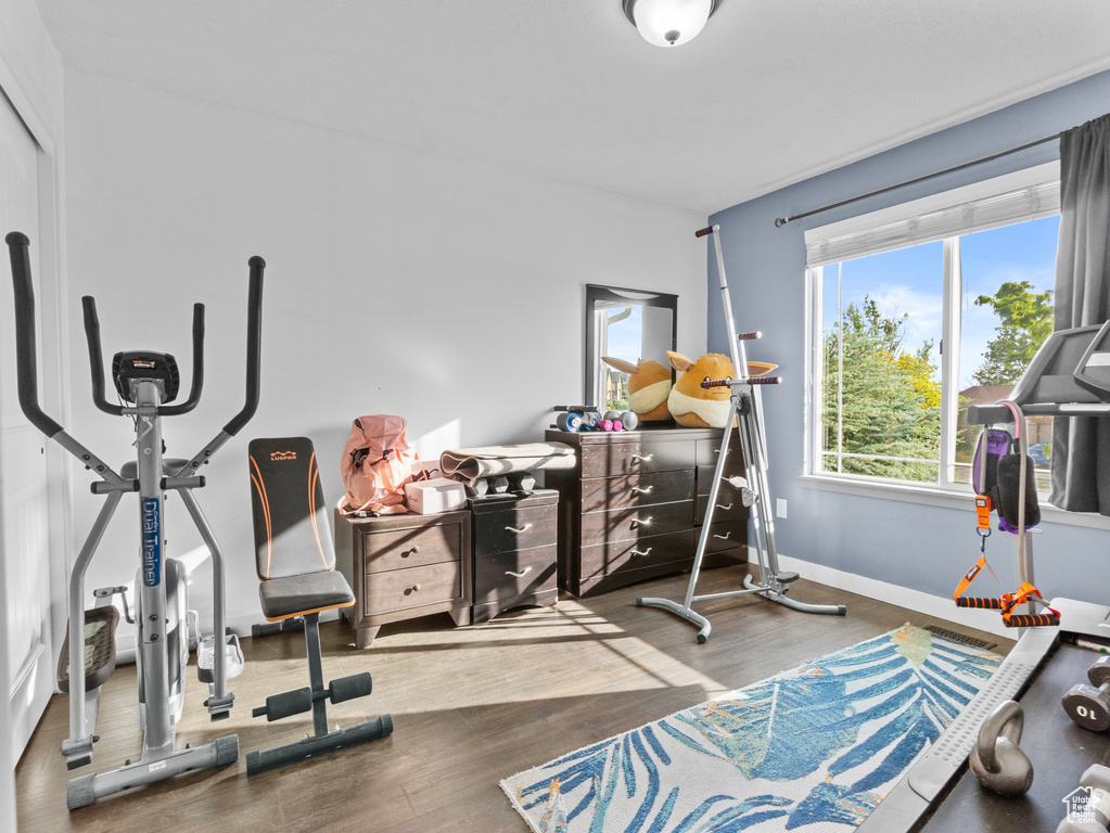 Exercise area featuring wood finished floors