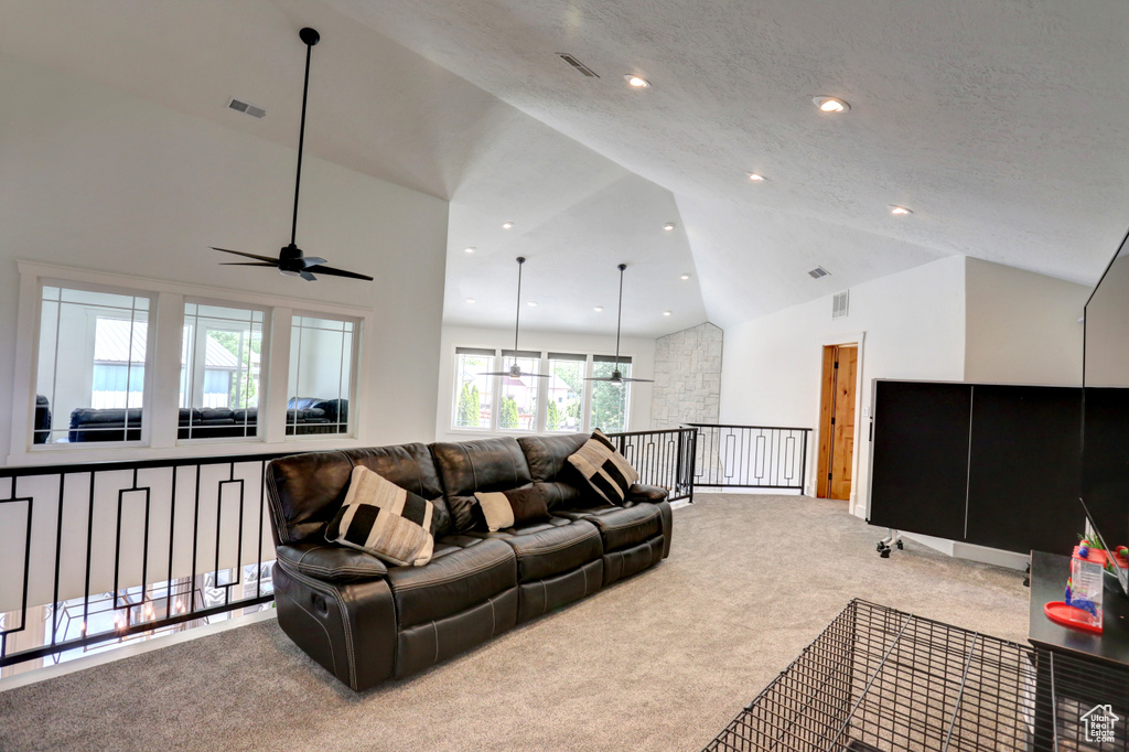 Living room with carpet, ceiling fan, high vaulted ceiling, and recessed lighting