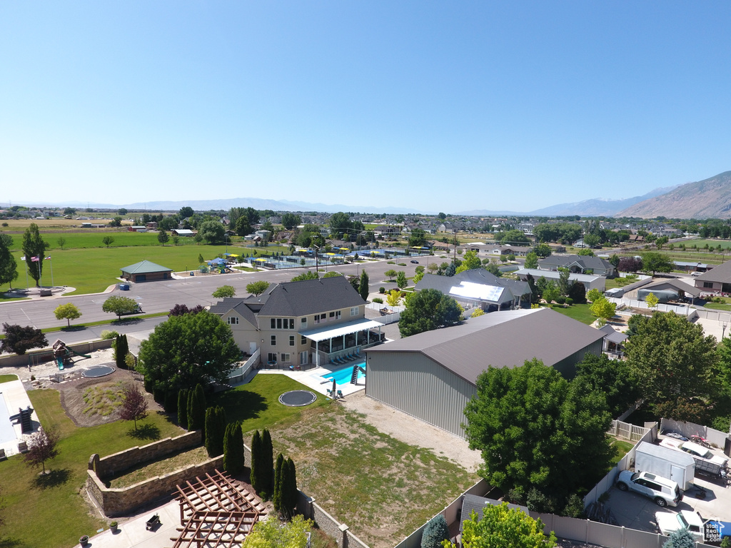 Aerial view of residential area with a mountainous background and a pool area