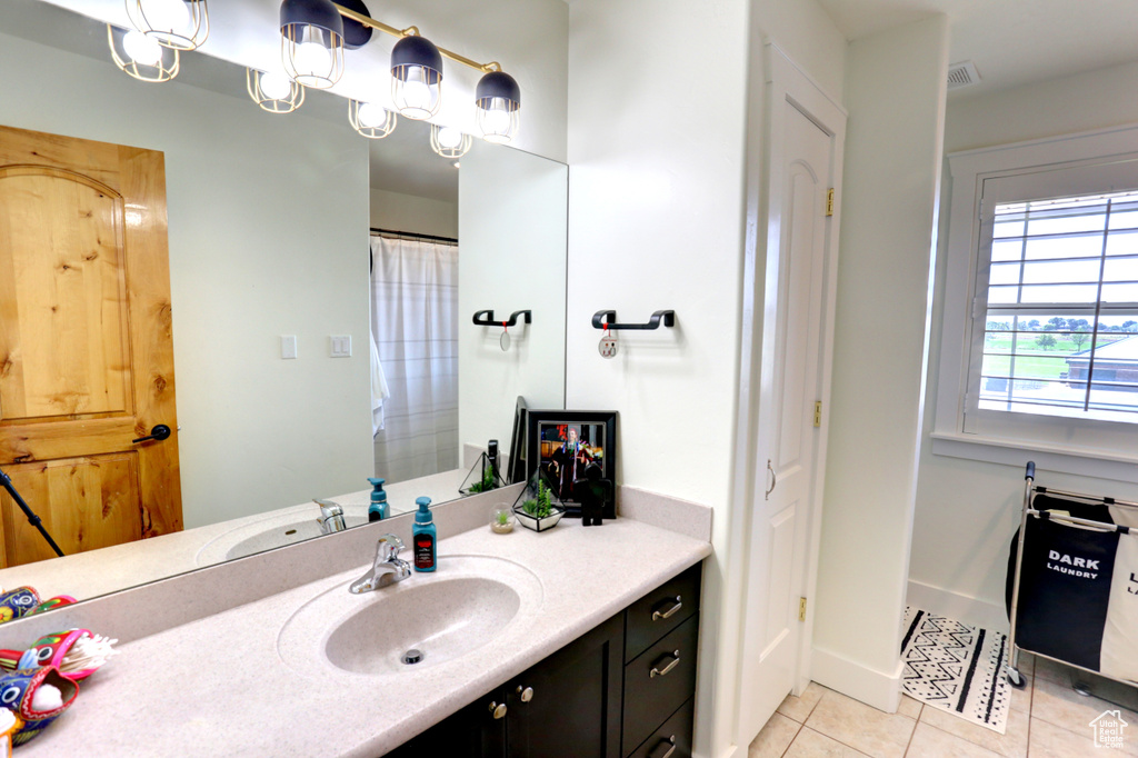 Bathroom featuring tile patterned floors and vanity