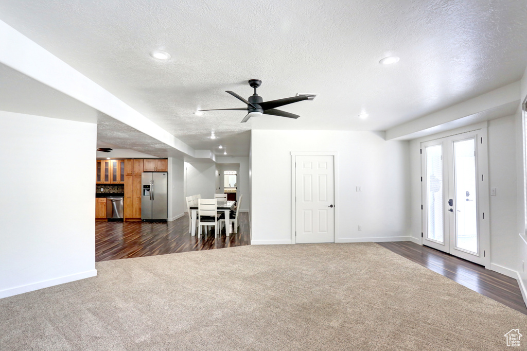 Living room featuring dark carpet, a textured ceiling, a ceiling fan, dark wood finished floors, and recessed lighting