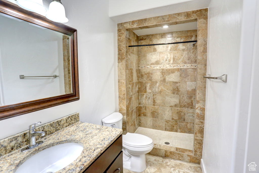 Full bathroom with vanity and a tile shower