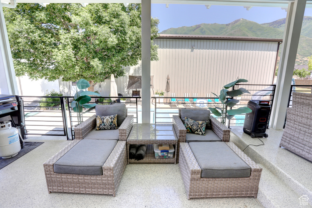 Patio / terrace with an outdoor hangout area and a mountain view
