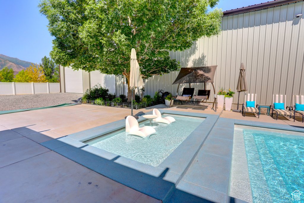 View of pool featuring a patio area and a mountain view