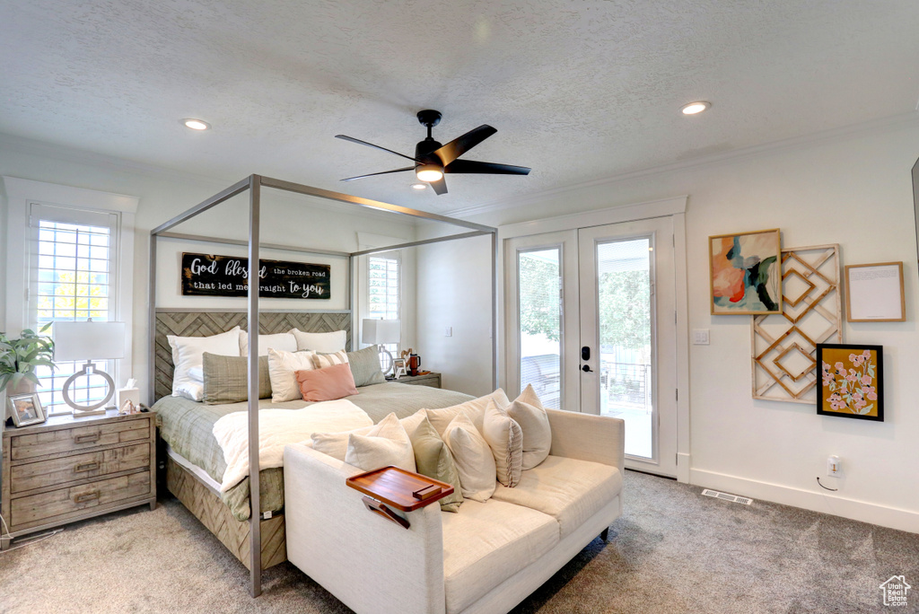 Bedroom featuring access to exterior, crown molding, light carpet, french doors, and a textured ceiling