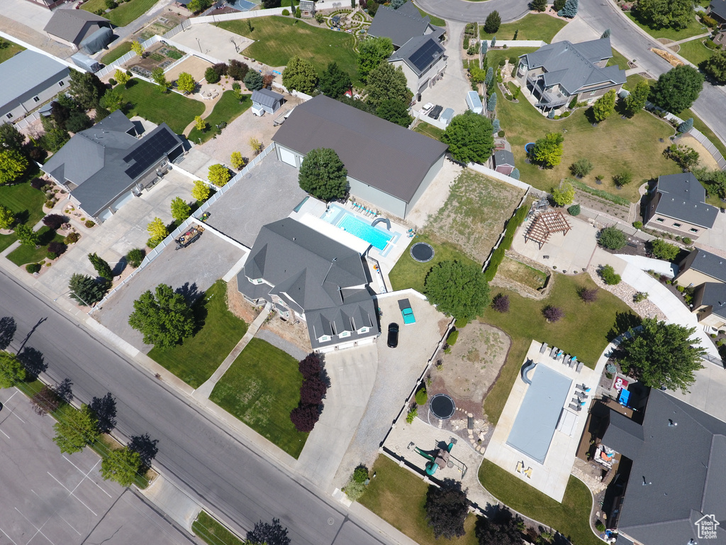 Aerial overview of property\'s location featuring a pool area and nearby suburban area