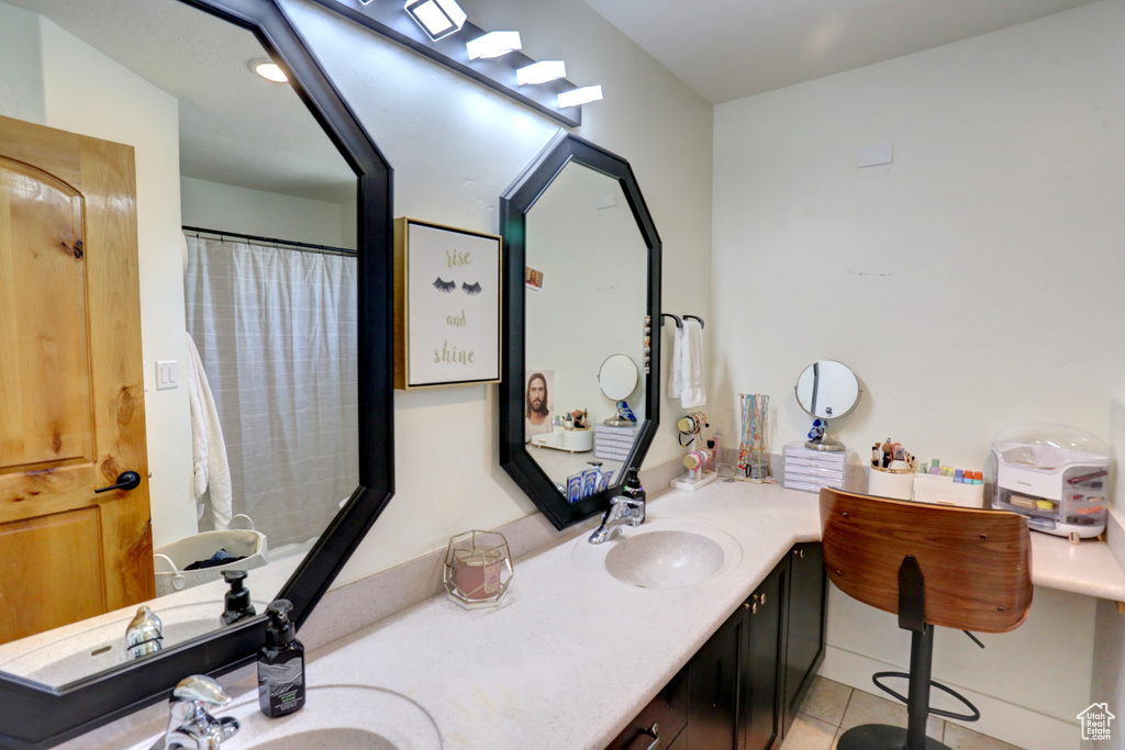 Bathroom featuring double vanity and tile patterned flooring