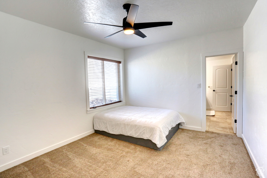 Bedroom with light colored carpet and ceiling fan