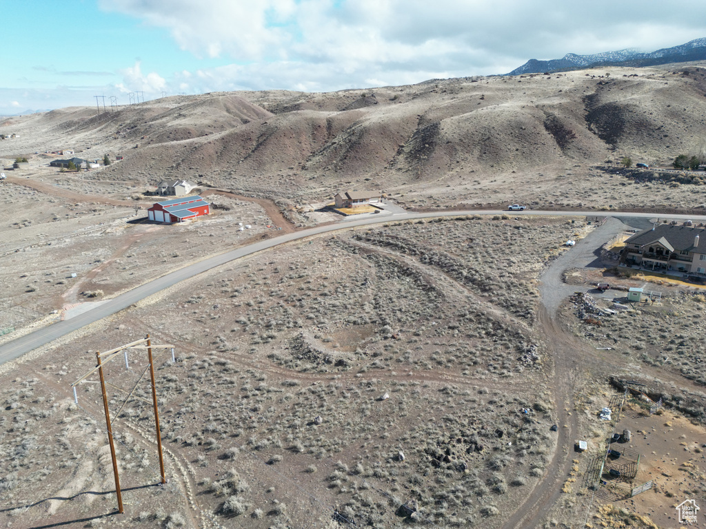 View of rural area with a mountain backdrop and a desert landscape