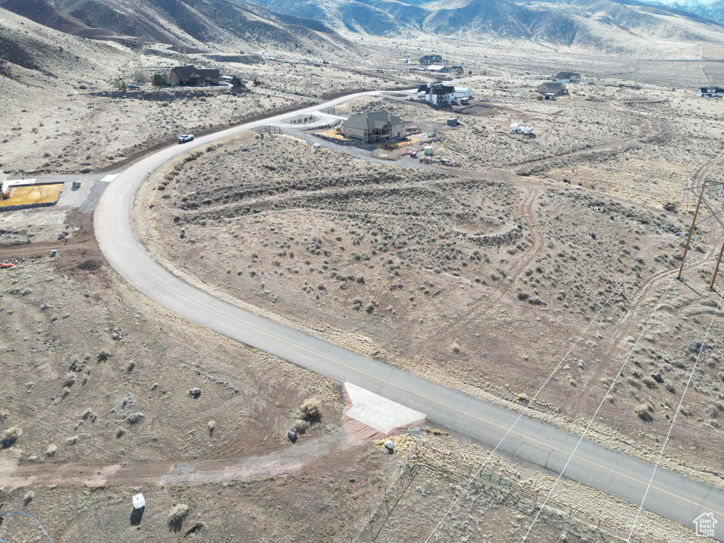 Aerial overview of property's location with a mountainous background and rural landscape