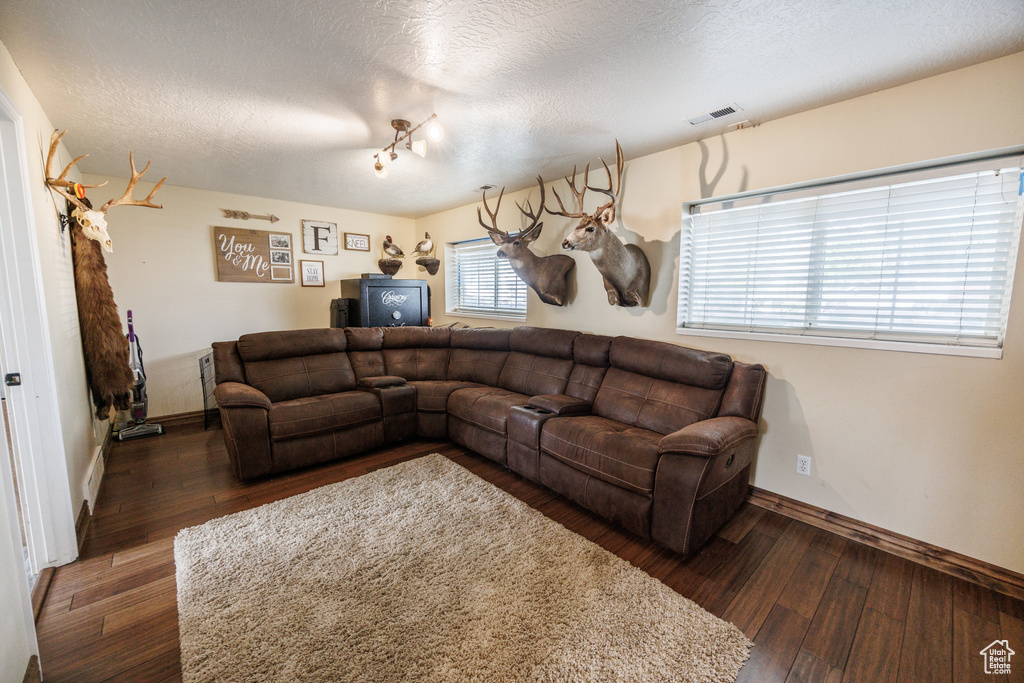 Living room with hardwood / wood-style flooring and a textured ceiling