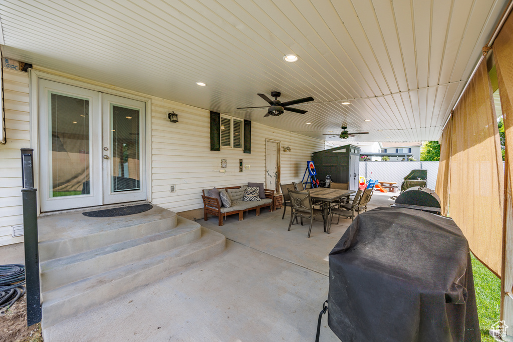 View of patio / terrace with french doors, an outdoor hangout area, outdoor dining area, grilling area, and a ceiling fan