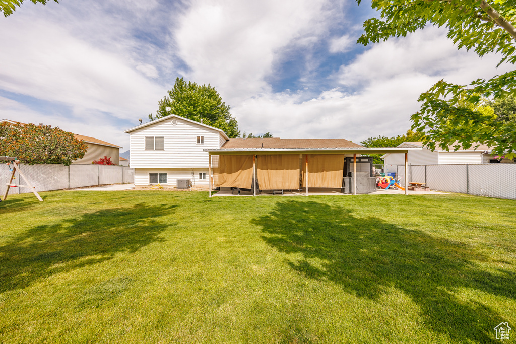 Rear view of house featuring a fenced backyard