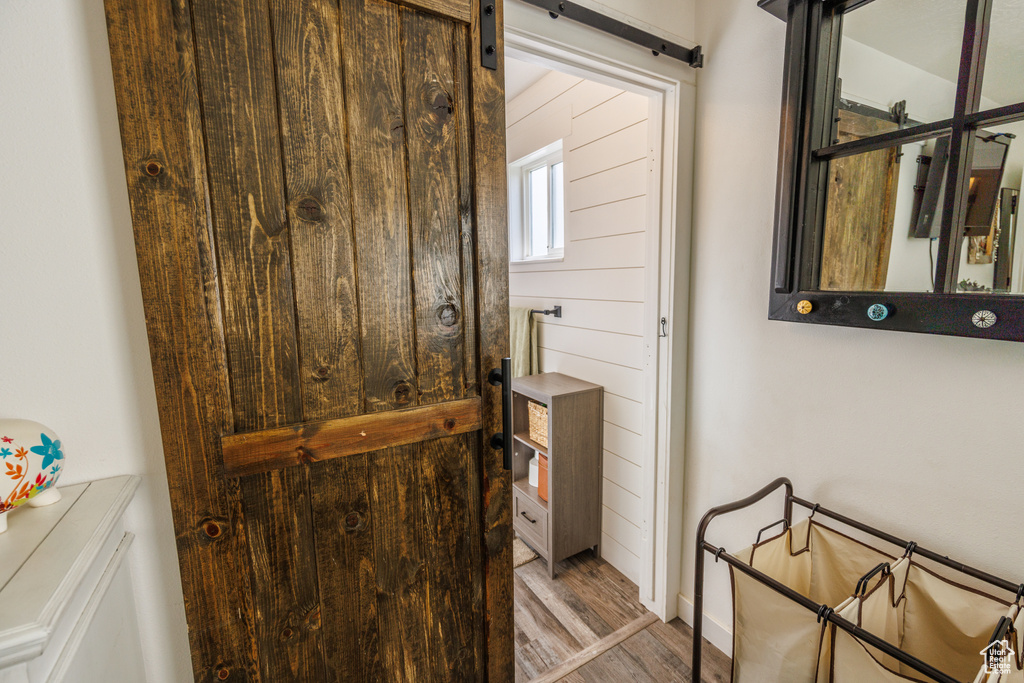 Doorway with wood finished floors and a barn door