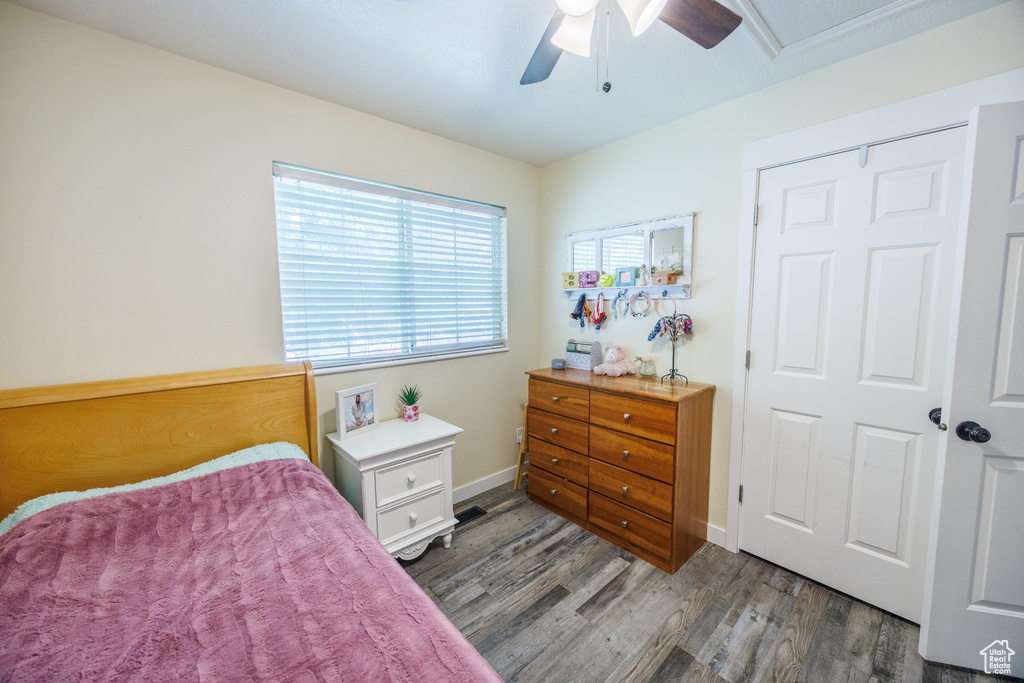 Bedroom featuring wood finished floors and a ceiling fan