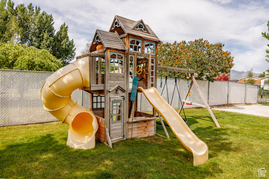 View of playground featuring a fenced backyard