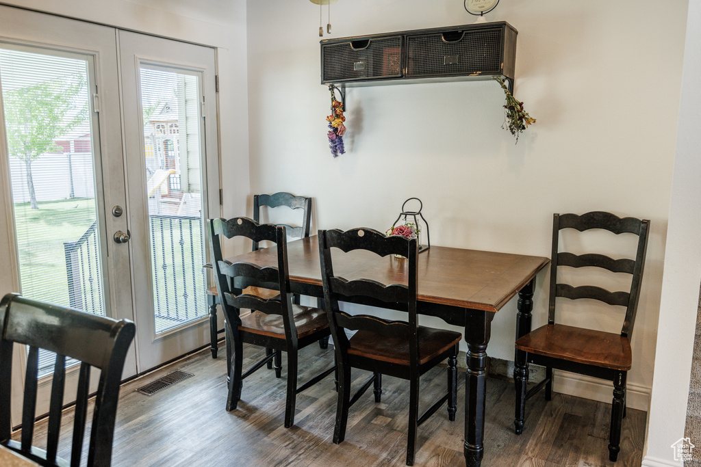 Dining space with wood finished floors and baseboards