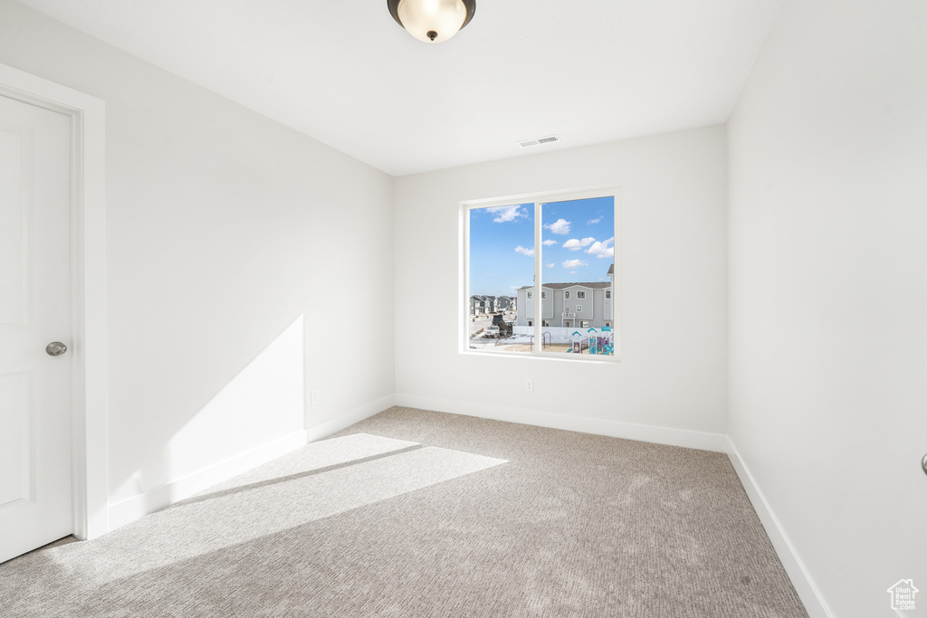 Unfurnished room featuring carpet floors and baseboards
