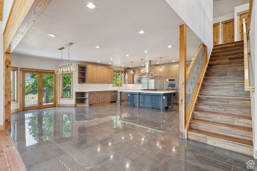 Staircase featuring recessed lighting, french doors, and a textured ceiling