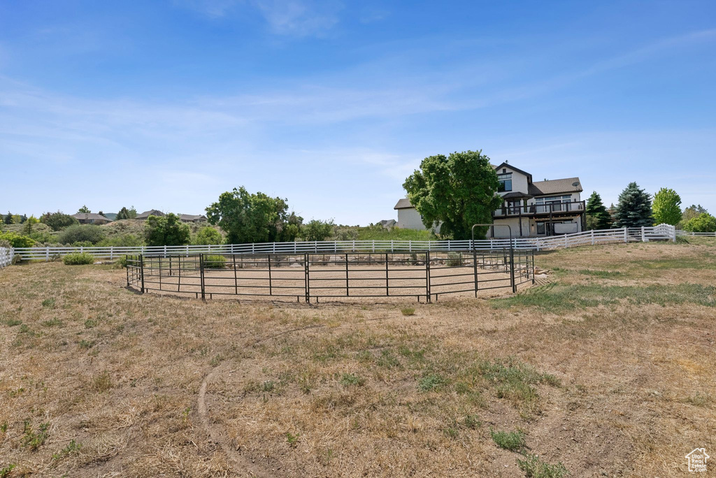View of yard with a view of rural / pastoral area and an enclosed riding area