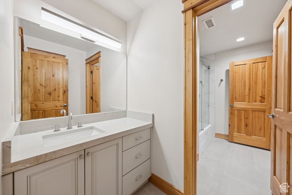 Full bathroom featuring vanity, tub / shower combination, and tile patterned flooring