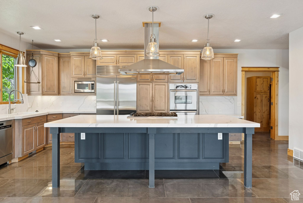 Kitchen featuring built in appliances, recessed lighting, a kitchen island, decorative backsplash, and a breakfast bar area