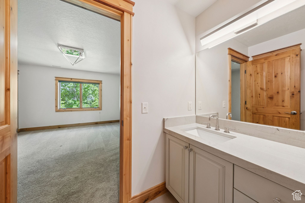 Bathroom with vanity and baseboards