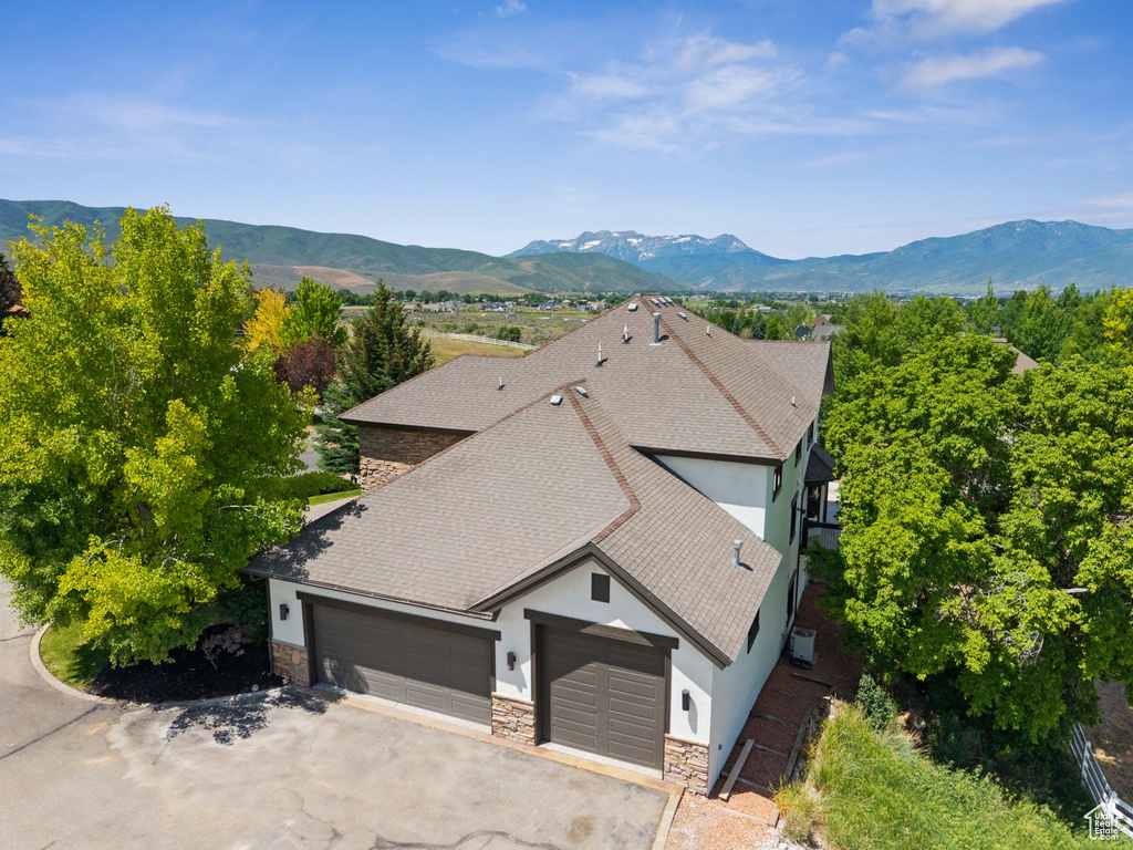 View of subject property with a mountain backdrop
