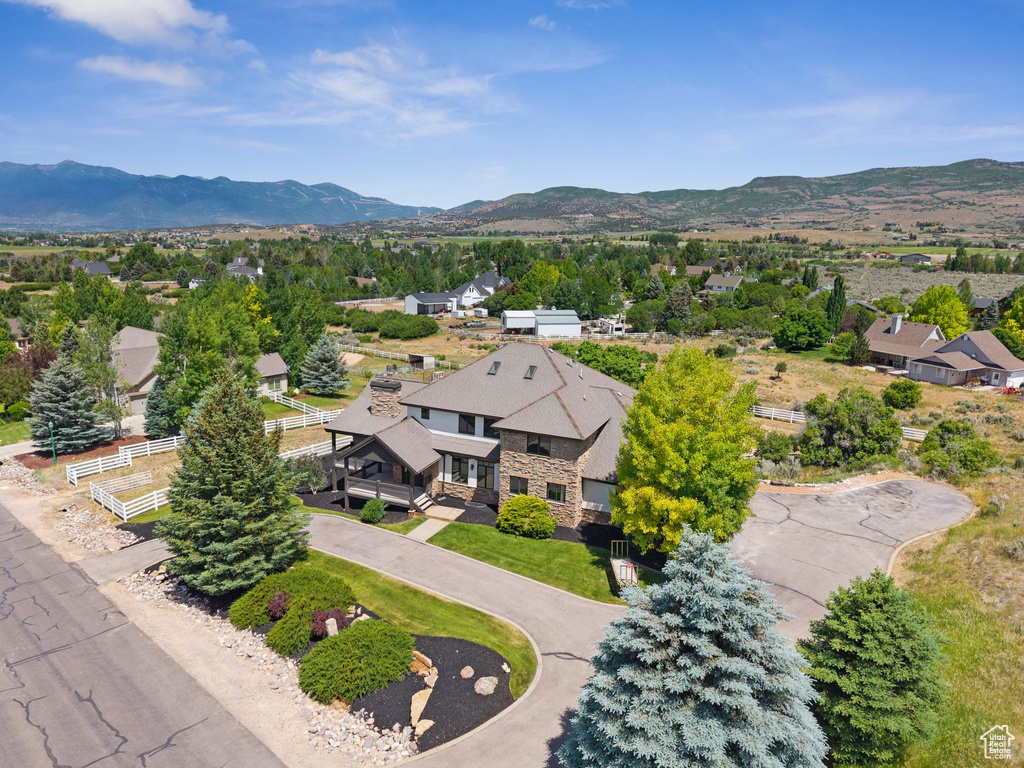 Aerial view of residential area featuring a mountainous background
