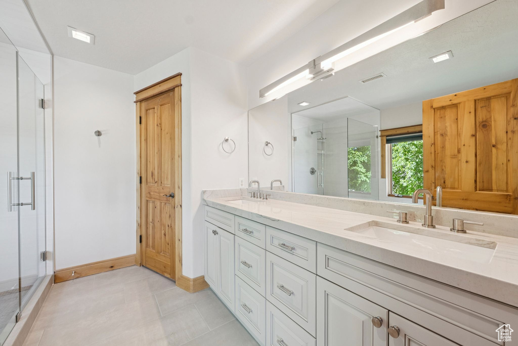 Bathroom with a shower stall and double vanity