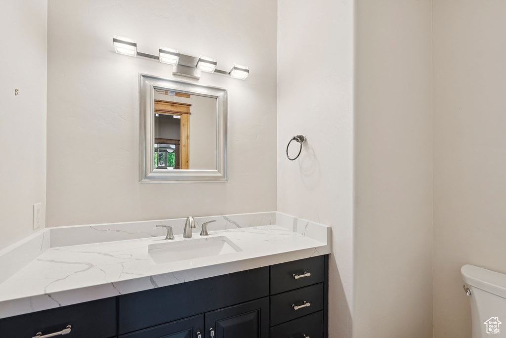 Half bath featuring vanity and toilet