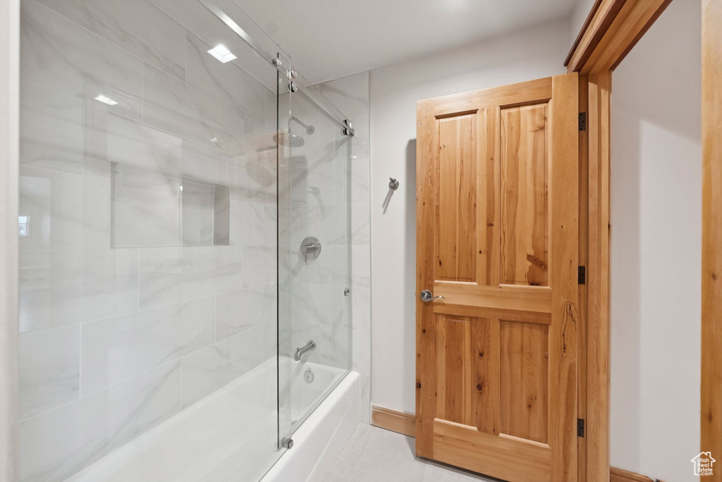 Full bathroom featuring bath / shower combo with glass door