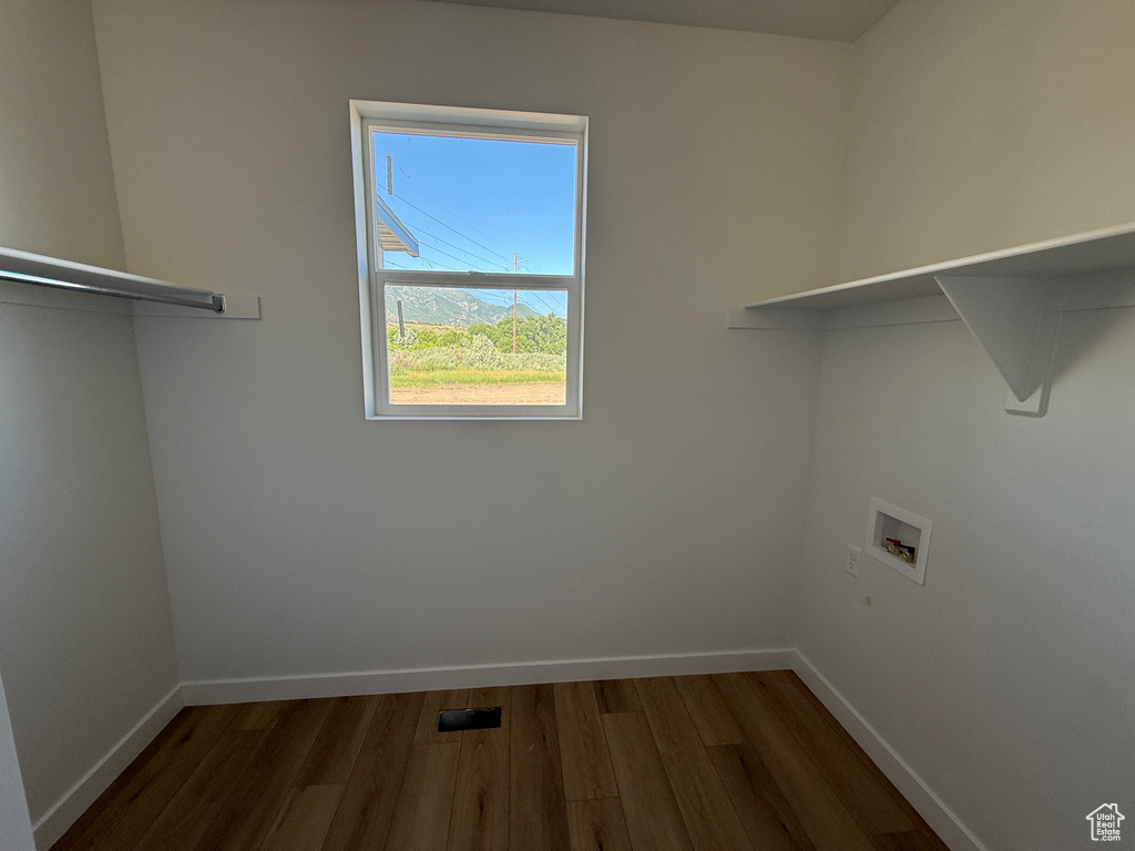 Laundry room featuring washer hookup and dark wood-style flooring