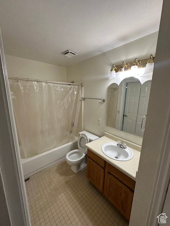 Bathroom with shower / bath combo and vanity