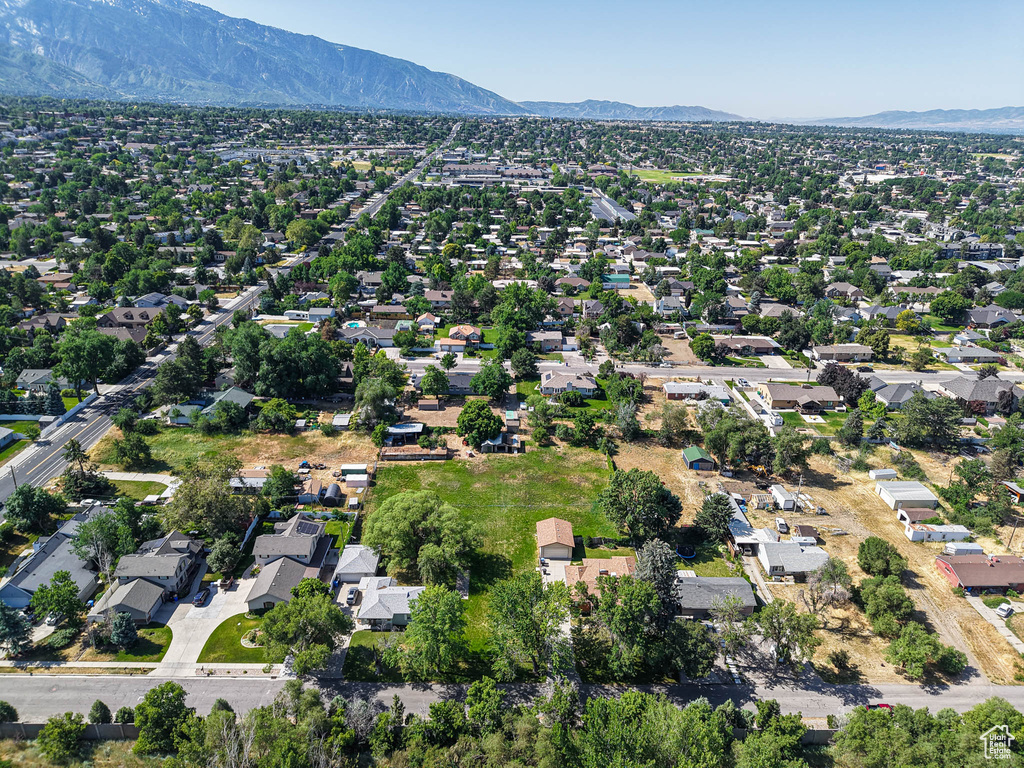 Aerial view of property and surrounding area with nearby suburban area