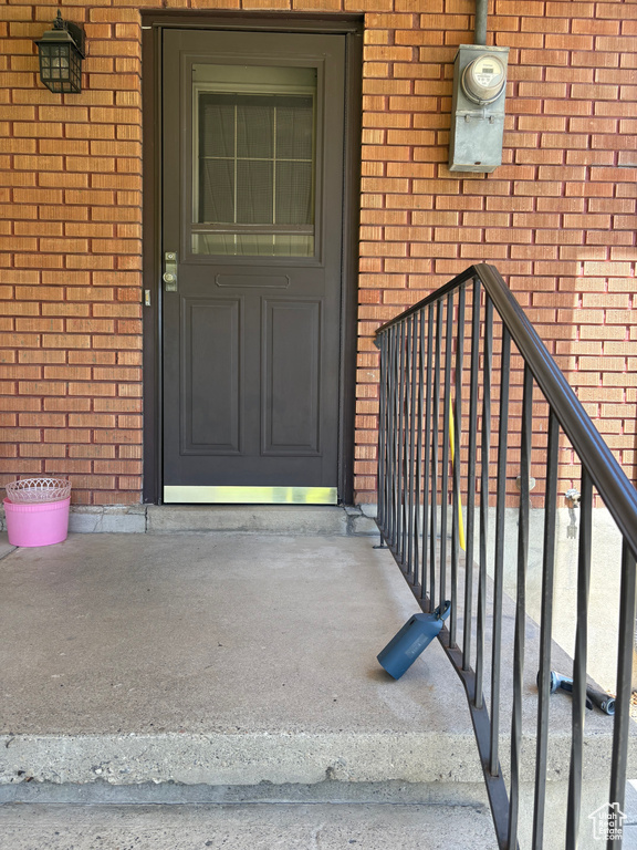 View of exterior entry with brick siding