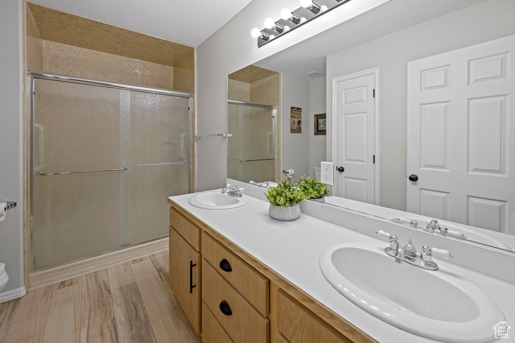 Full bathroom with a shower stall and double vanity