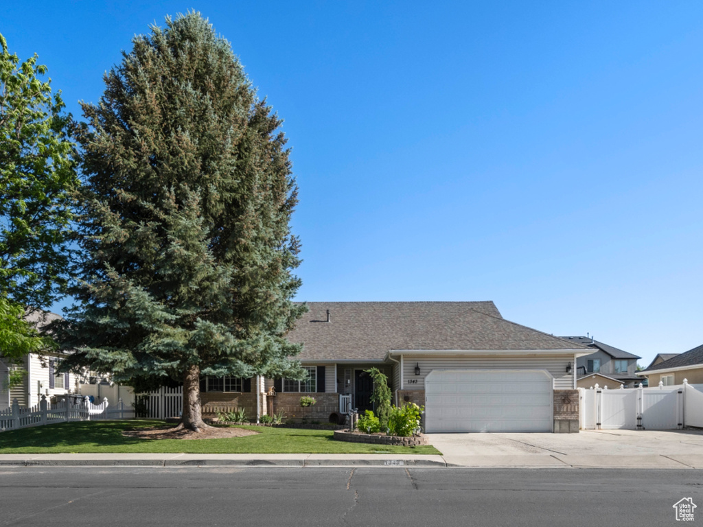 View of front of home featuring an attached garage and concrete driveway