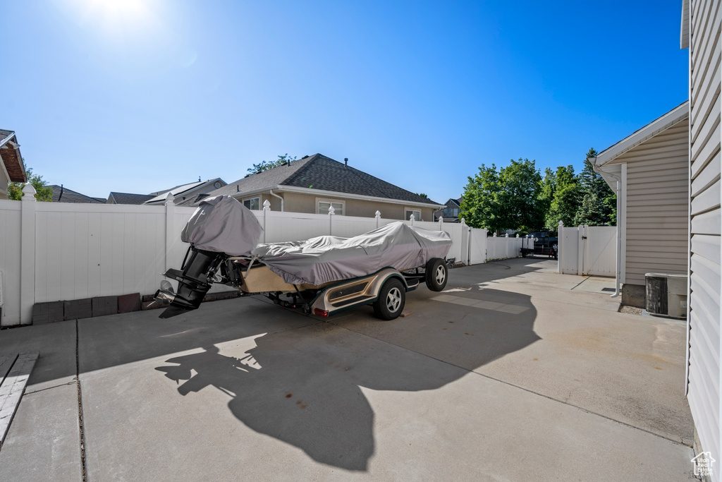 View of parking / parking lot featuring a fenced backyard and concrete driveway