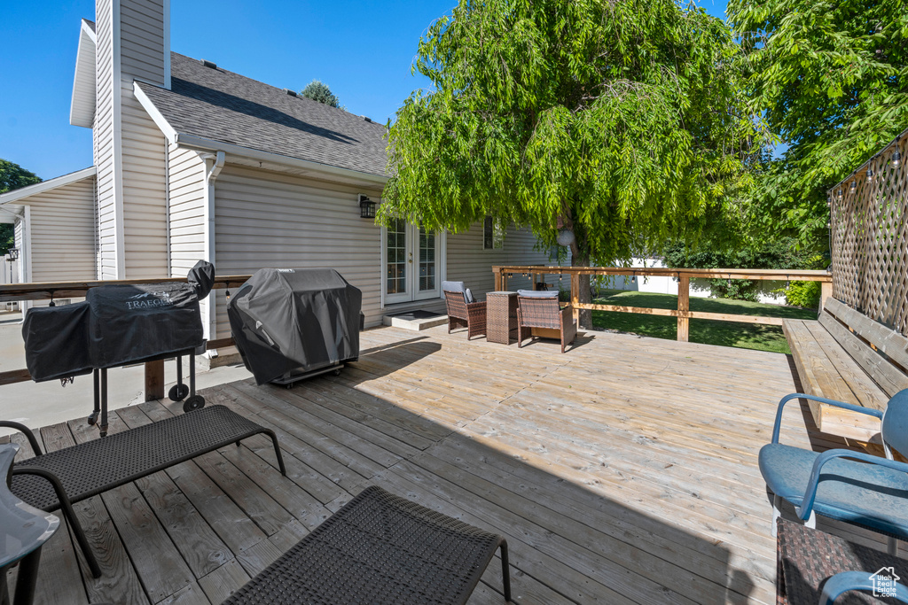 Wooden deck featuring french doors and grilling area