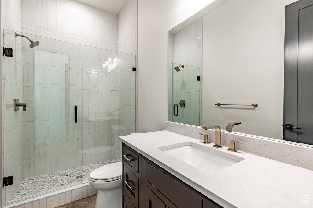 Full bath featuring vanity and a shower stall