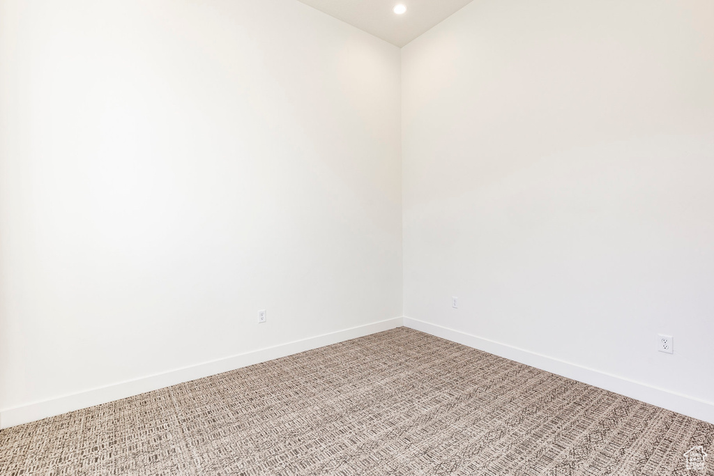 Empty room featuring light colored carpet and recessed lighting