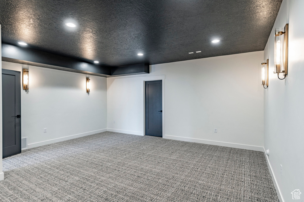 Empty room with recessed lighting, carpet flooring, and a textured ceiling