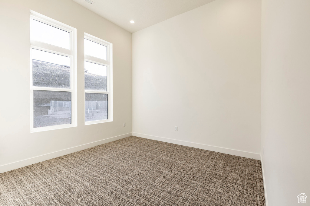 Empty room featuring carpet and recessed lighting