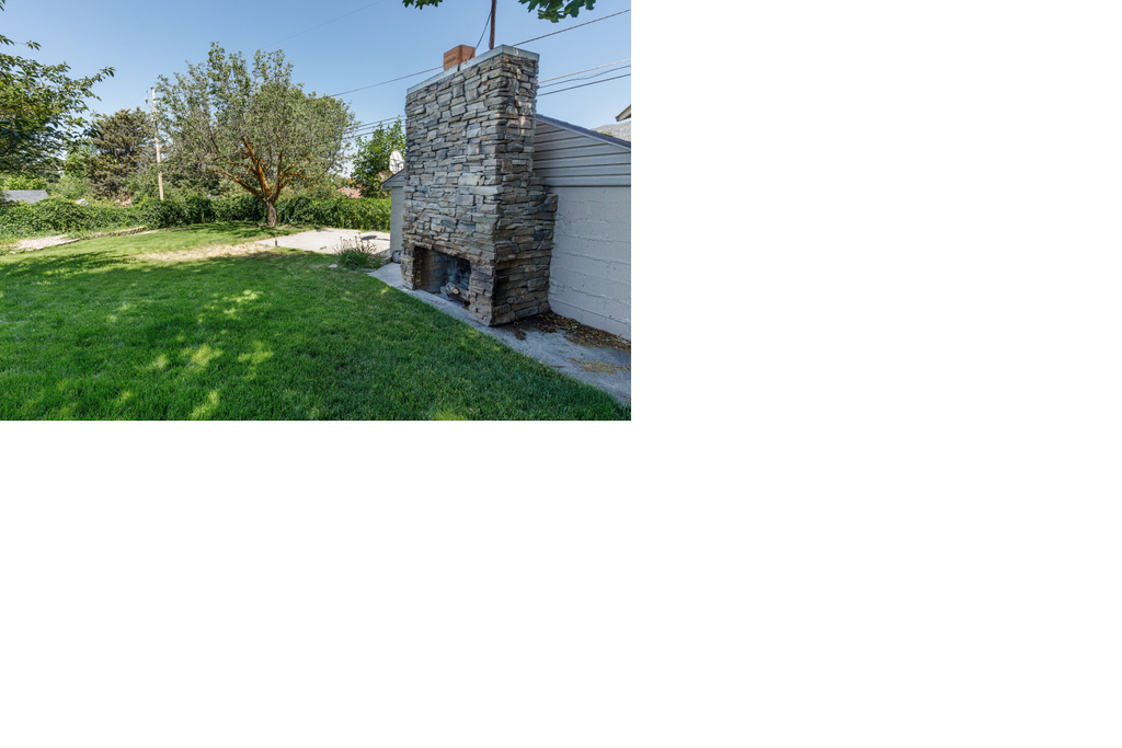 View of green lawn with a fireplace