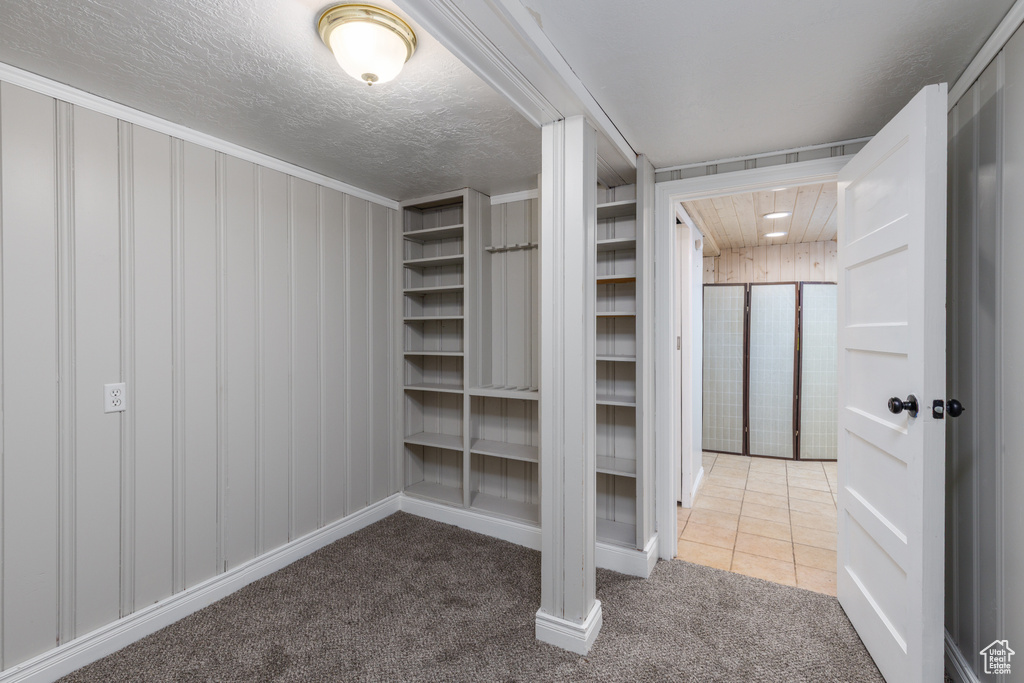 Spacious closet with carpet floors