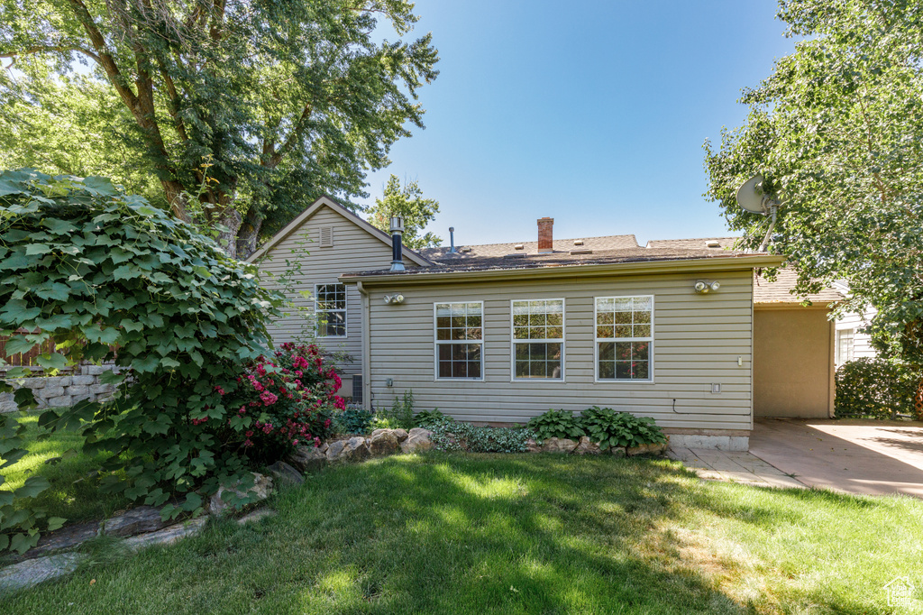Back of property featuring a yard and a patio