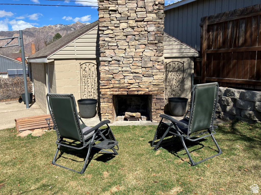 View of yard featuring an outdoor stone fireplace