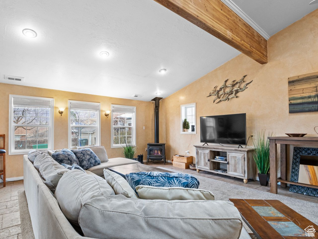 Living area featuring a wood stove and baseboards